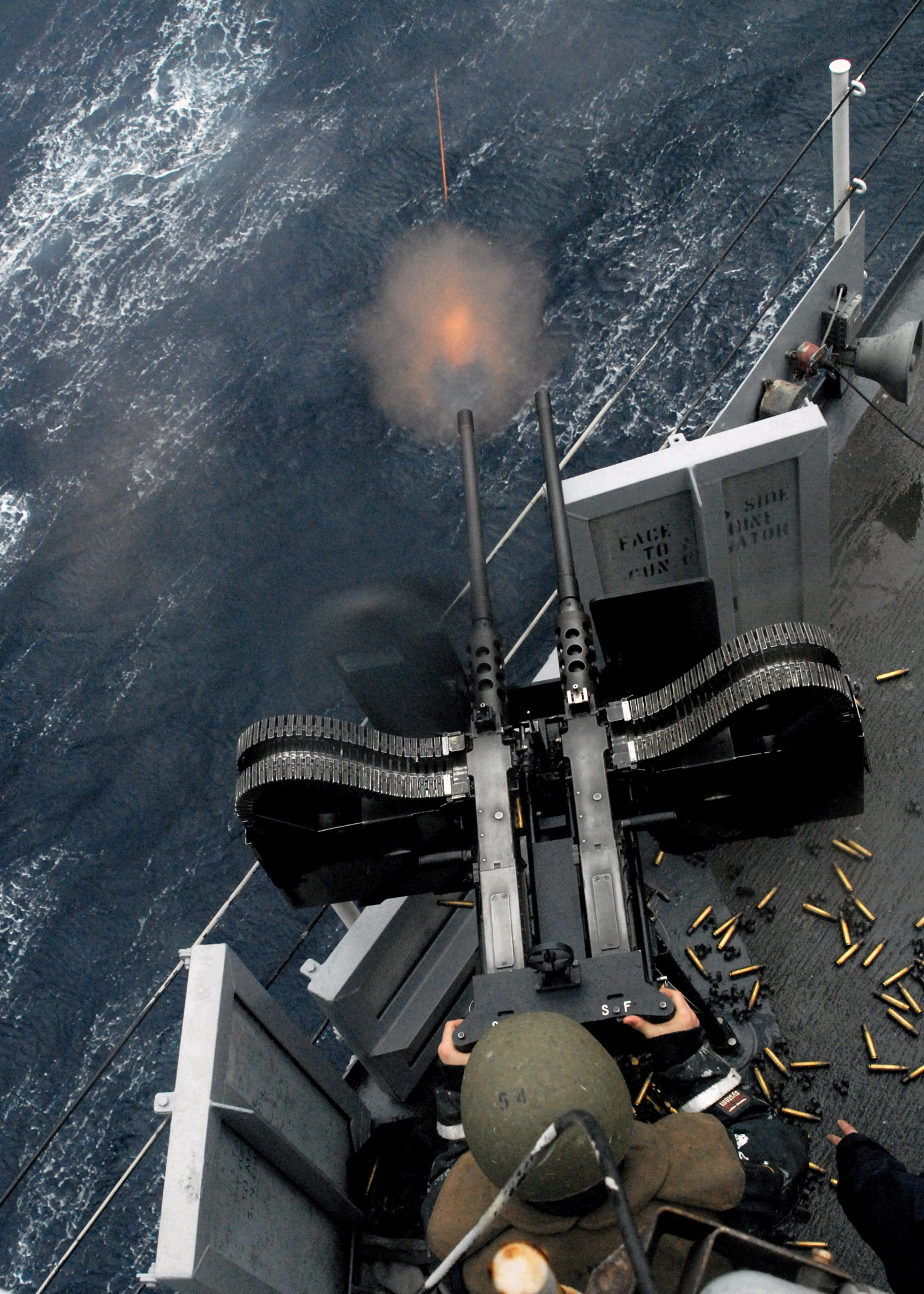 US_Navy_080209-N-5067K-299_A_gunner_stationed_aboard_the_amphibious_transport_dock_ship_USS_Juneau_(LPD_10)_fires_a_twin_50-caliber_machine-gun_during_a_live_fire_training_exercise.jpg