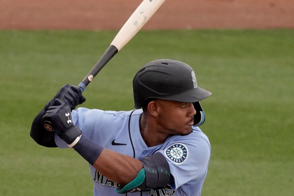 Seattle Mariners' Julio Rodriguez bats during the second inning of a spring training baseball game against the Texas Rangers Monday, March 28, 2022, in Peoria, Ariz. (AP Photo/Charlie Riedel)