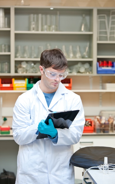 concentrated-male-scientist-writing-clipboard_13339-220617.jpg