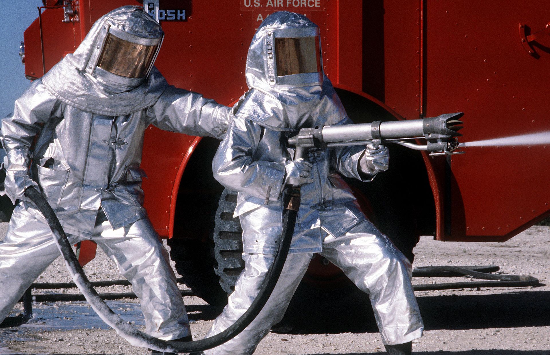 1920px-Fire_fighters_practice_with_spraying_equipment%2C_March_1981.jpg
