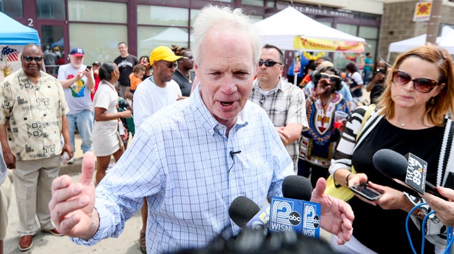 A large crowd begins to form and some start to boo Sen. Ron Johnson as he makes a speech during the Juneteenth Day celebration on Saturday, June 19, 2021, in Milwaukee.